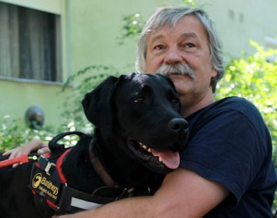 Andras is embracing his dog, Google