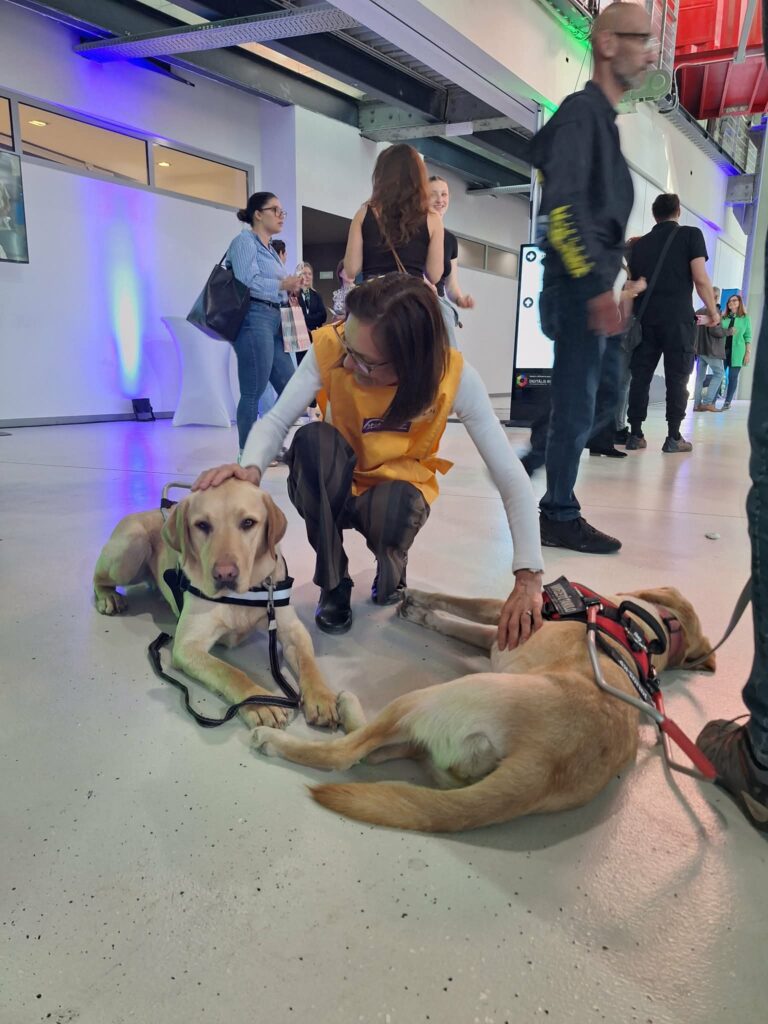 A woman is petting two of our dogs.