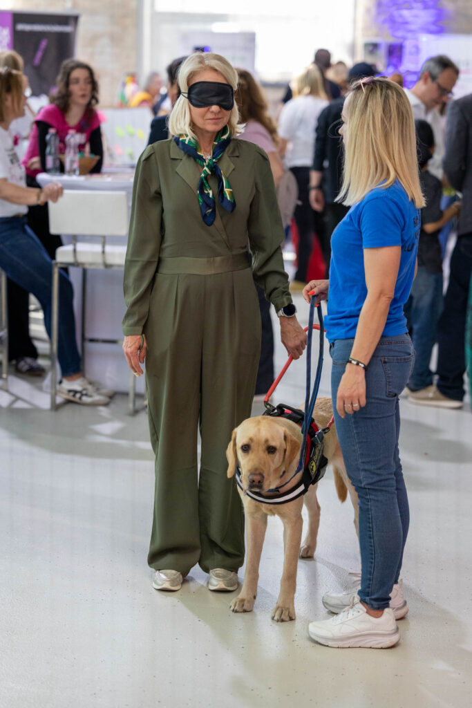 Our trainer, Emese and Garas are demonstrating what is it like to walk with a guide dog while blindfolded.